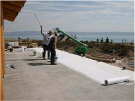Roofing Contractors Installing Waterproof Membrane For Roof And Home Protection