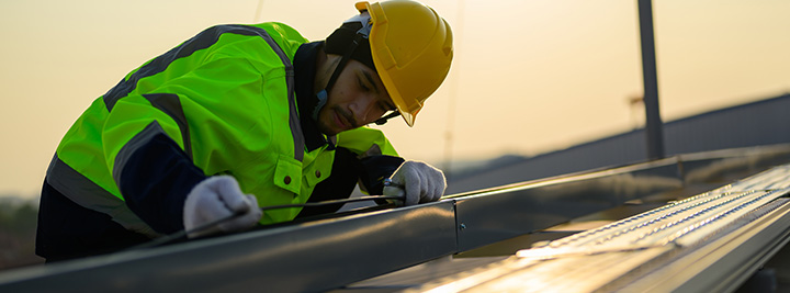 Experienced Roofer Repairing a Metal Roof in Arizona