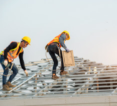 Licensed roofers installing tile roof on a commercial building in Mesa