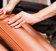 Mesa Roofing contractor positioning a tile during installation